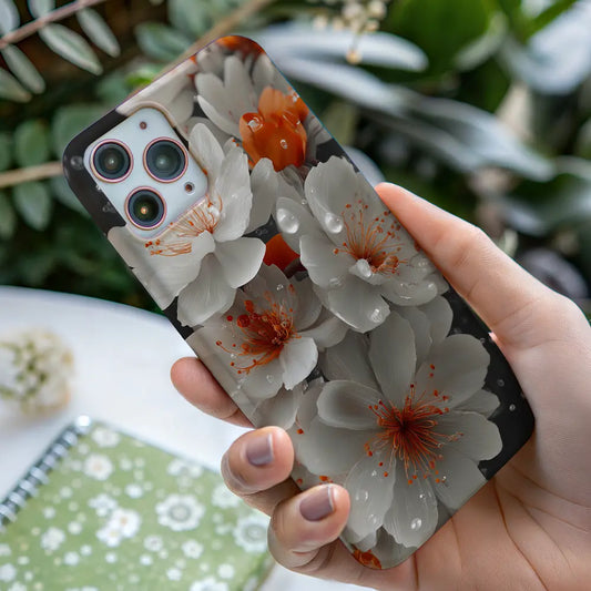 White cherry blossom phone case held in hand, showing calm floral artwork with natures soft detail in everyday use.