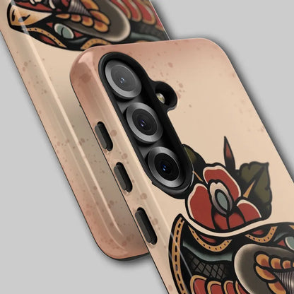 Close-up of snake fangs and red rose details on the phone case.